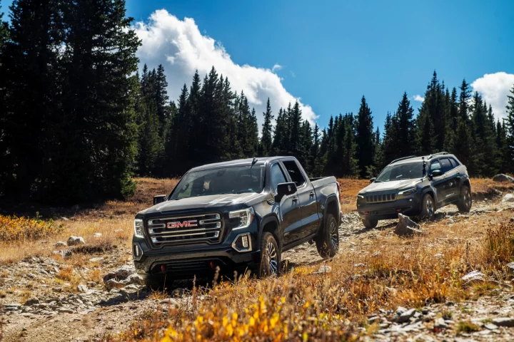 The GMC Sierra AT4 leads the way and the Jeep Cherokee Trailhawk follows close behind, ready to prove itself equal