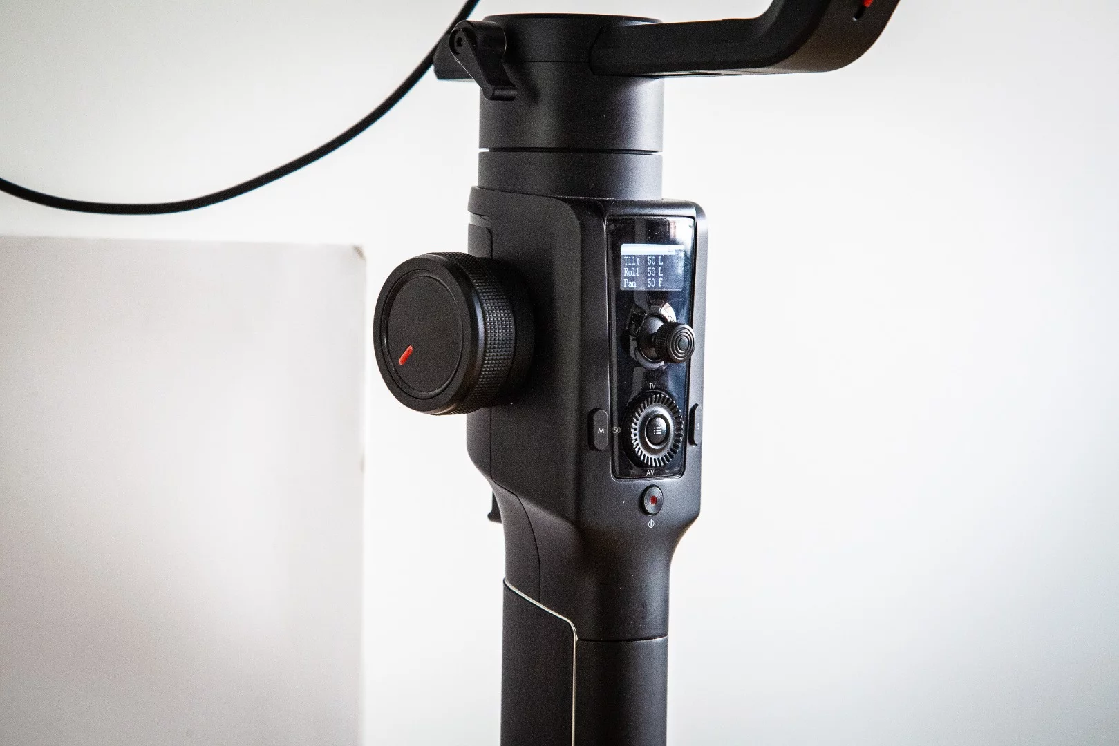 Large wheel on the left of the handle can be set to control a number of functions, including focus/zoom