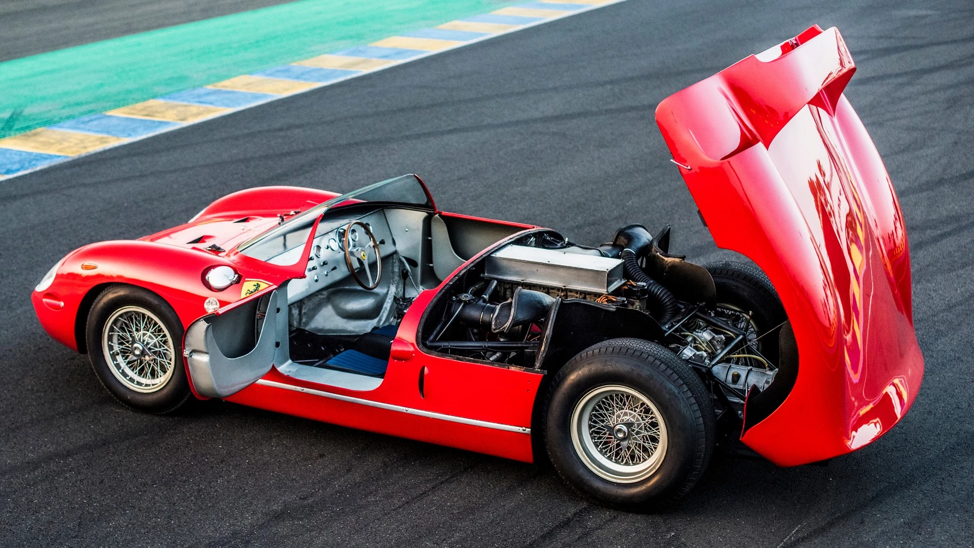 In 1963, the tiny 775 kg (dry) mid-engined Ferrari 250P driven by Ludovico Scarfiotti and Lorenzo Bandini, won the world's most important race by more than 200 km (16 laps), setting a new record distance for the race, becoming the first car to win the race without the traditional front-engined layout, and it was Scuderia Ferrari's fourth consecutive victory in the race.