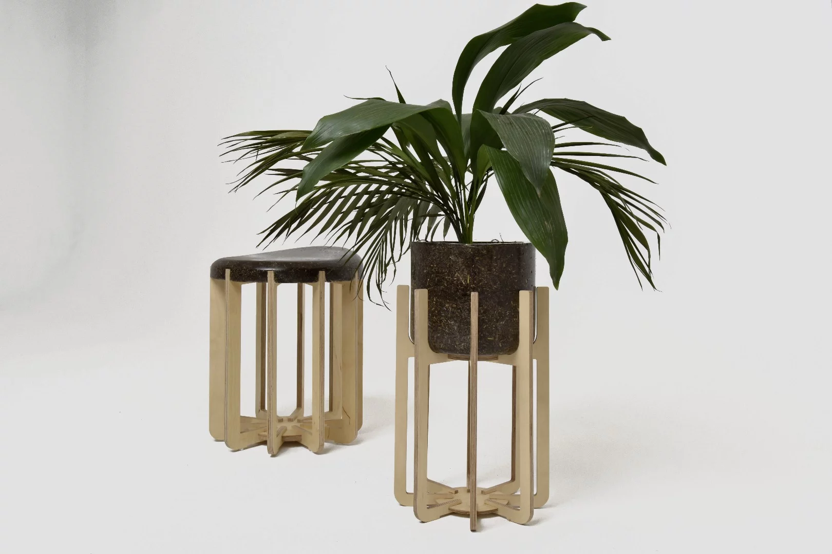 The stool and flower pot are mounted on wood stands, which are also recyclable