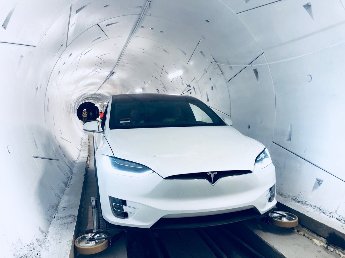 A Tesla inside The Boring Company's first tunnel, fitted with retractable wheel gear