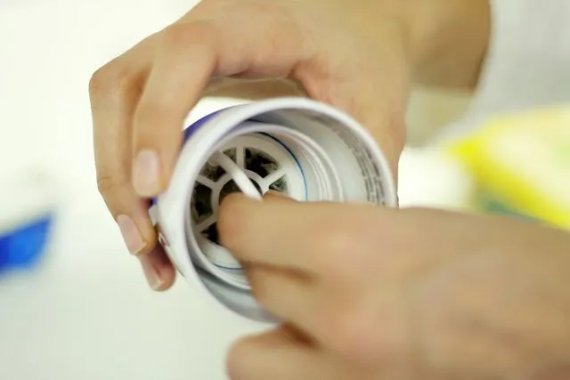 The tea bag is held in place near the mouth of the special water bottle