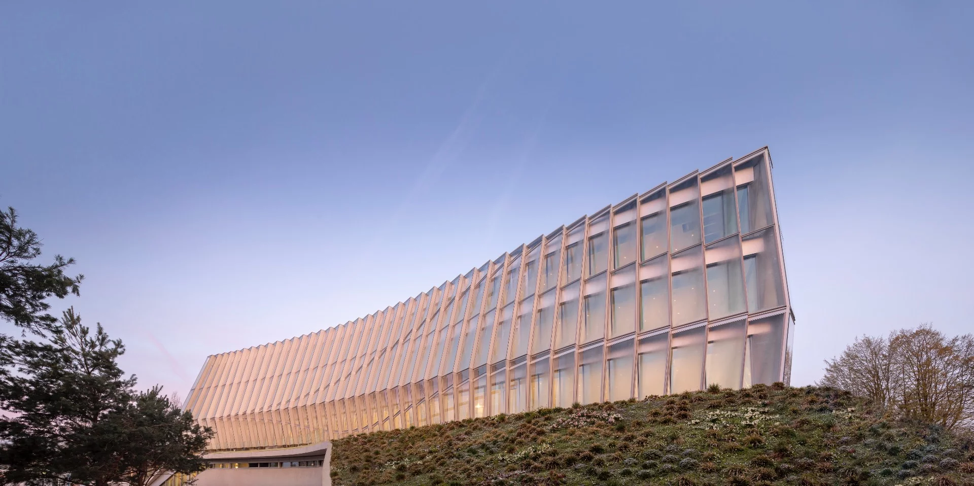 The Olympic House's glazed facade is meant to both reflect the IOC's commitment to transparency and emulate the movements of an athlete