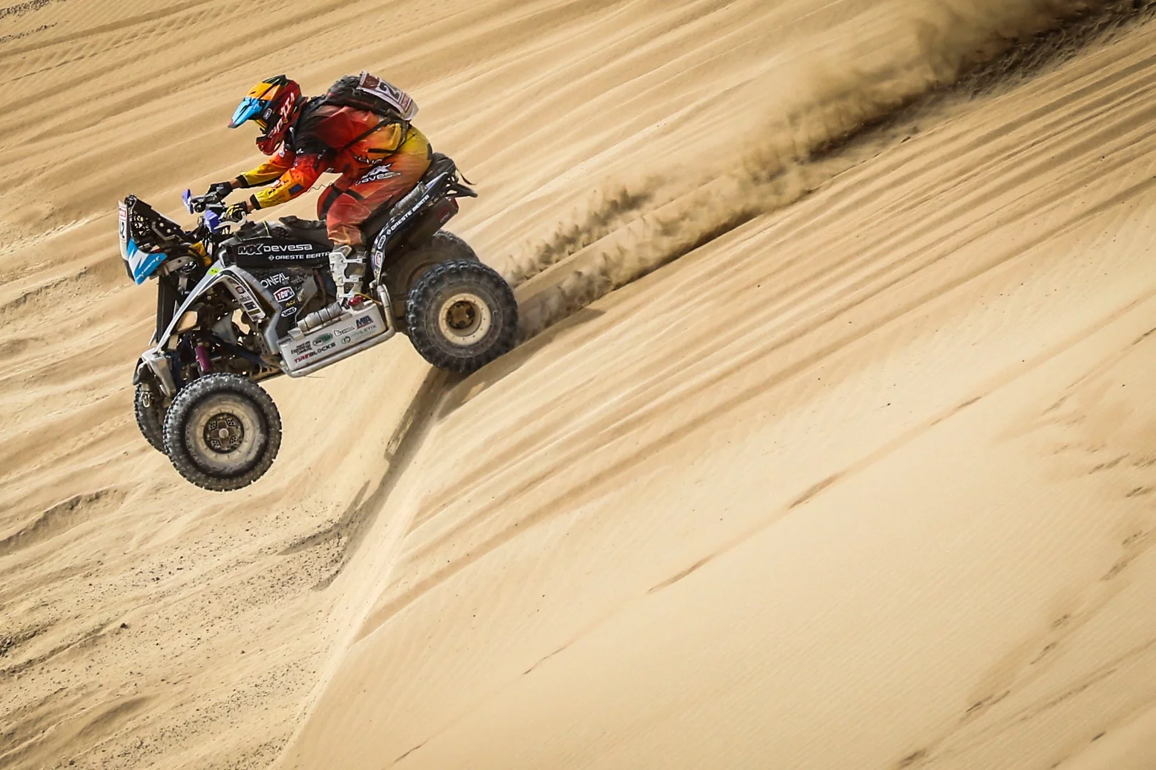 A Yamaha quad rider attacks the sand
