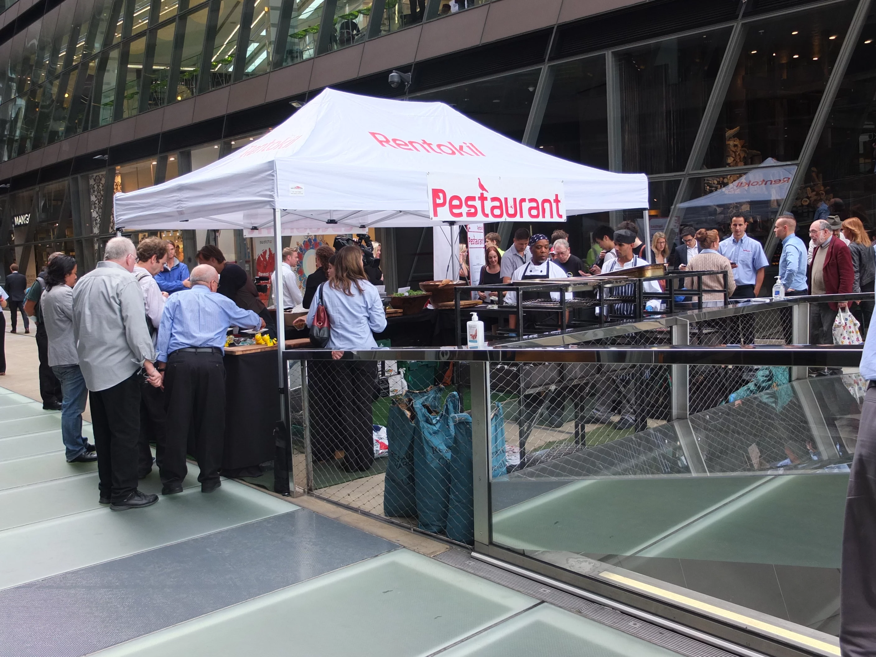 People gathered to sample insect snacks before the kitchen had even opened (Photo: Gizmag)