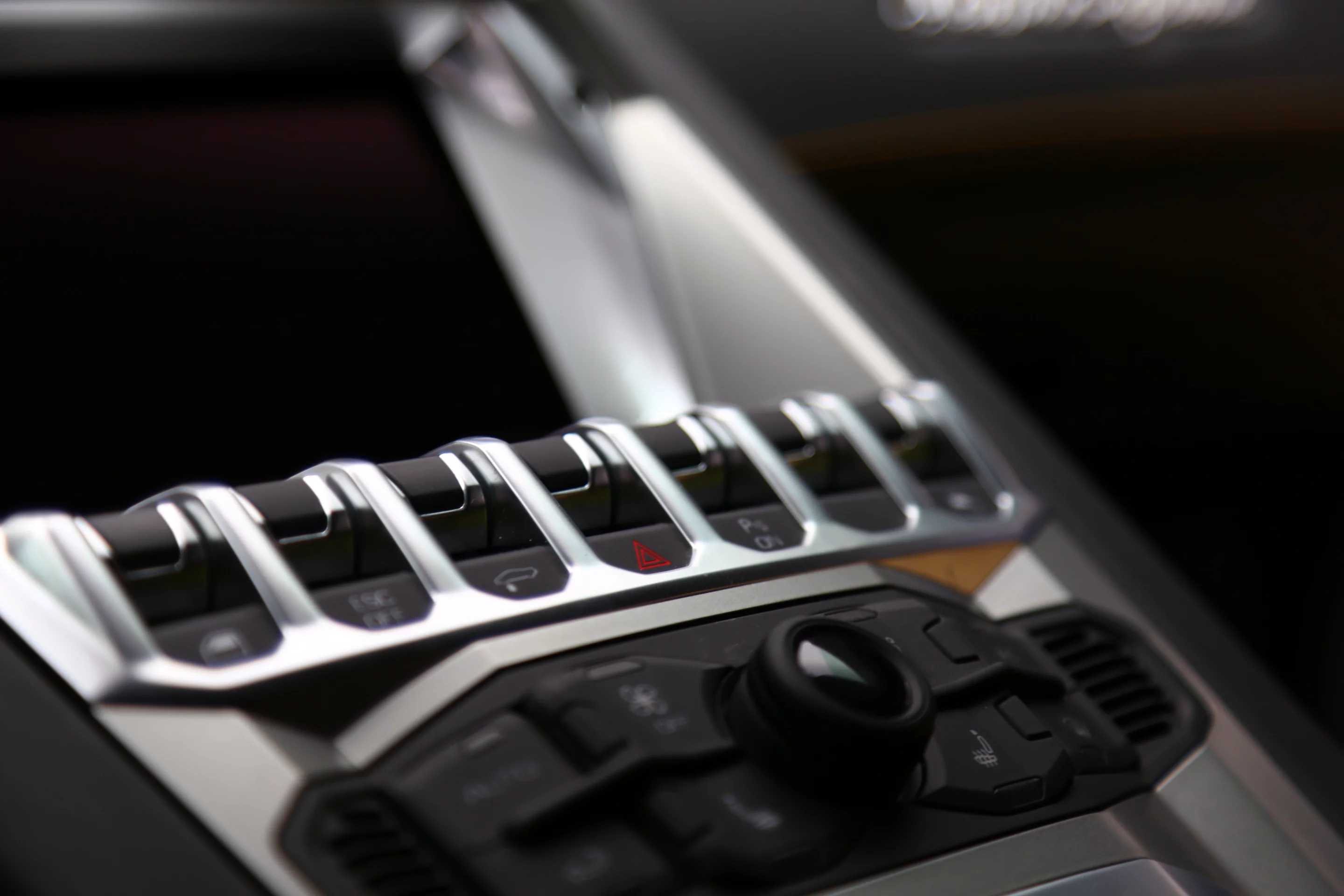 The console mounted switch panel includes a suspension raising switch to help the Aventador clear speed bumps and the like (Photo: Angus MacKenzie/Gizmag.com)