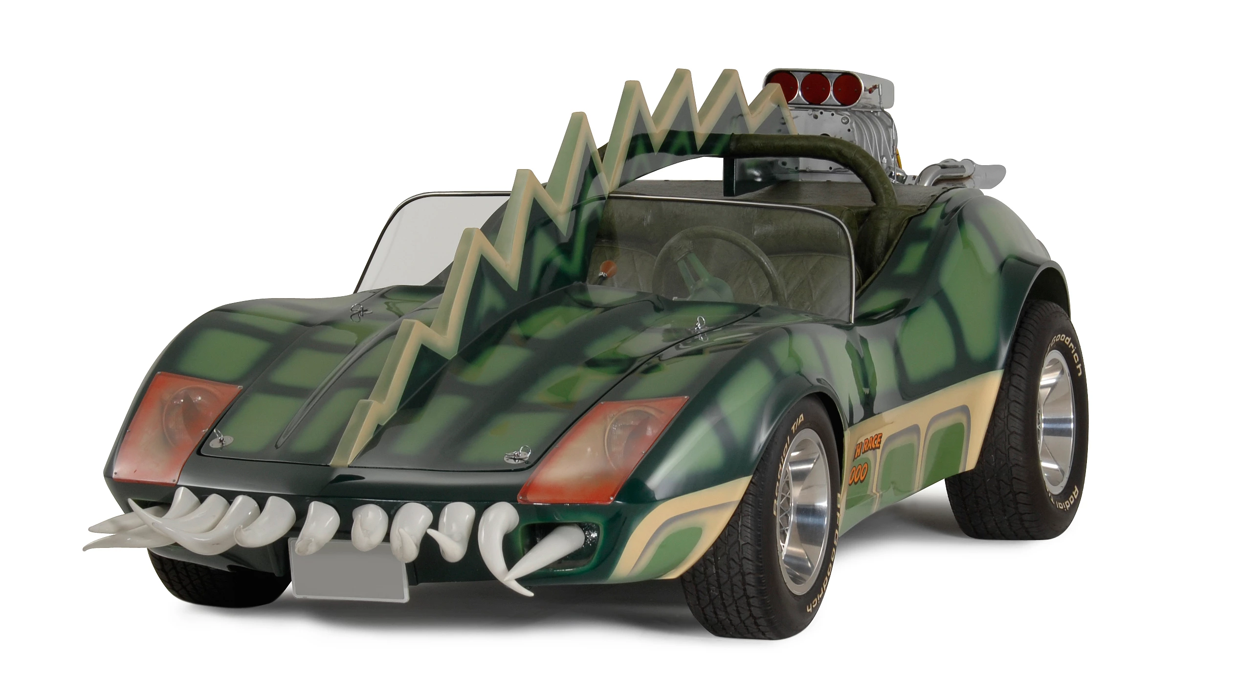 The car that is coming to auction is the Alligator Corvette driven by Carradine in Death Race 2000 (1975). The one-of-a-kind “alligator” Corvette (it's actually a Volkswagen chassis with an air-cooled Corvair motor), is expected to fetch between $20,000 and $25,000, despite the fact it got lots of screen time as Carradine (Frankenstein) fights against his deadly rival Stallone (Machine Gun Joe).