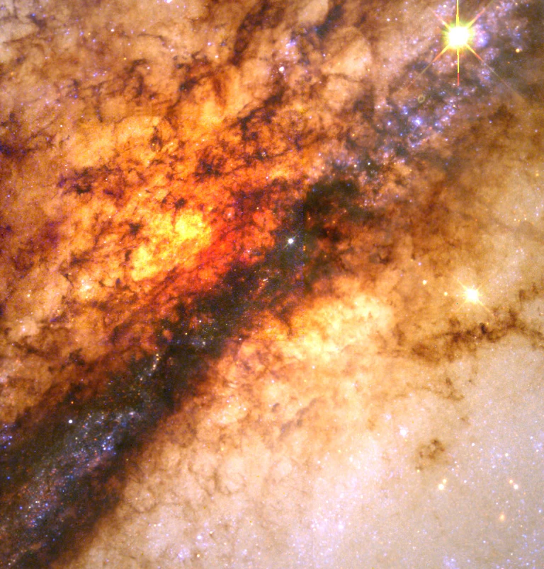 A close-up high resolution Wide Field Planetary Camera 2 image of the dramatic dust disk which is thought to be the remnant of a smaller spiral galaxy that merged with the large elliptical galaxy