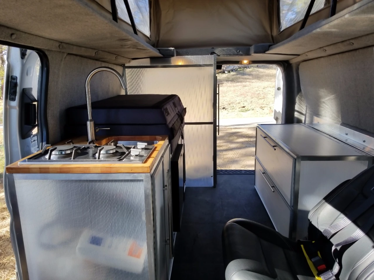 The passenger side includes the kitchen, storage cabinet and toilet room