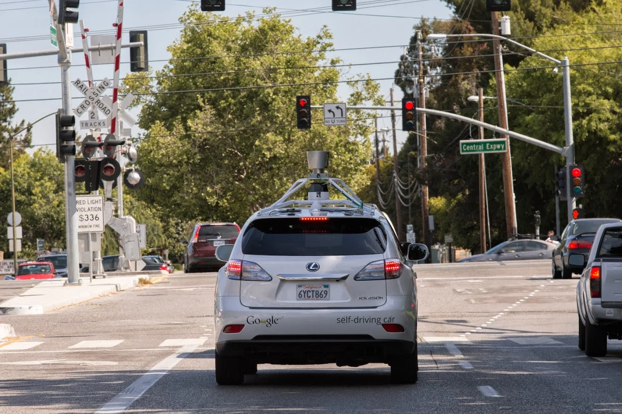 The Google Self-Driving Car prototype, based on a Lexis SUV, waits patiently at a traffic light