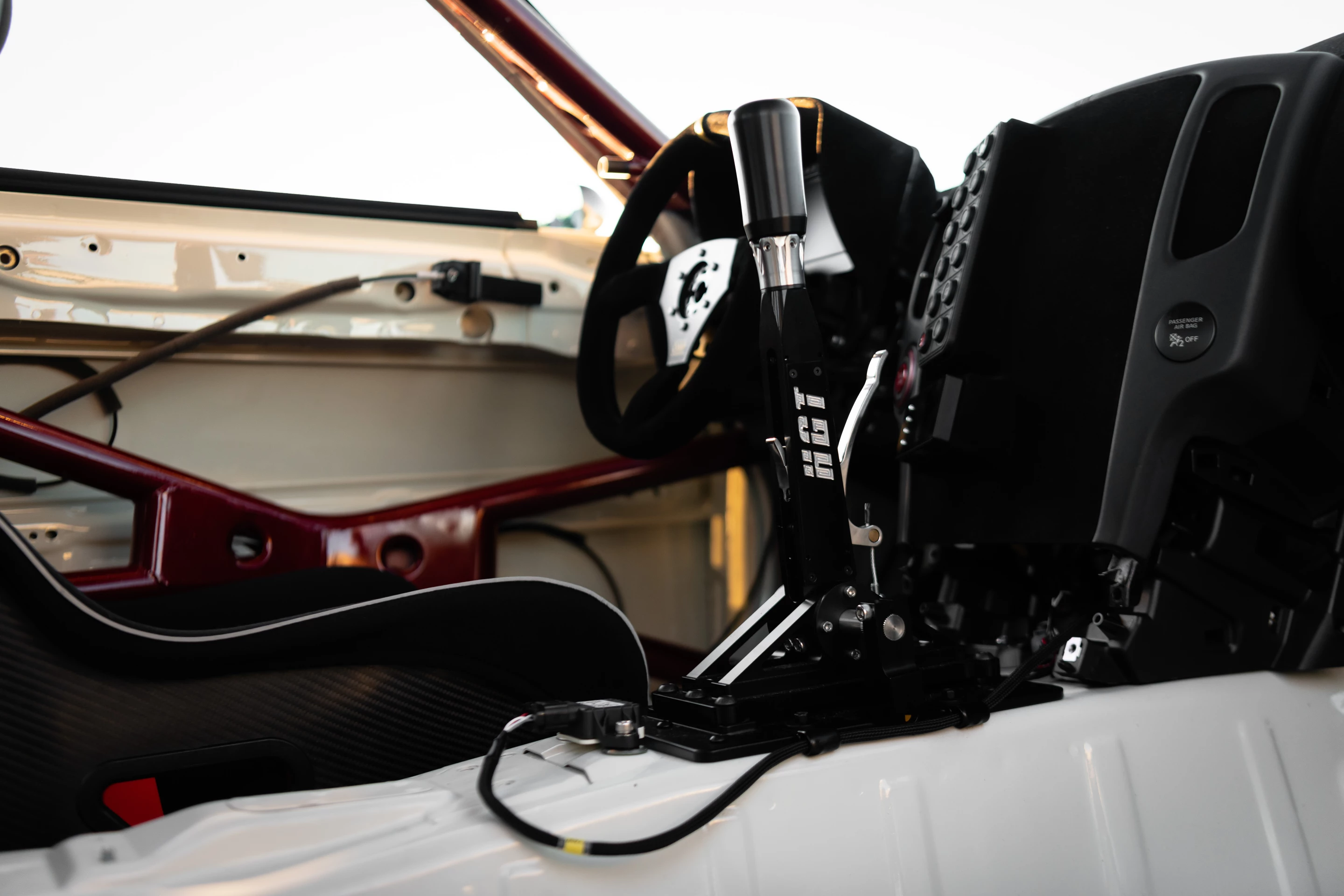 The interior of the 370Z Time Attack consists of a FIA-approved OMP HRC-R Carbon Air race seat, a custom instrument panel, and quick-release steering wheel