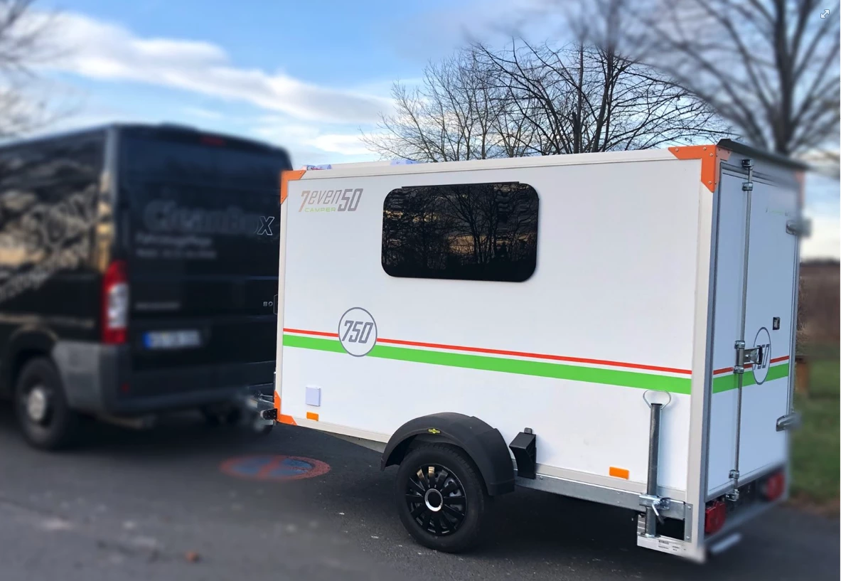 What looks like a basic cargo trailer outside is actually a cozy mini-camper