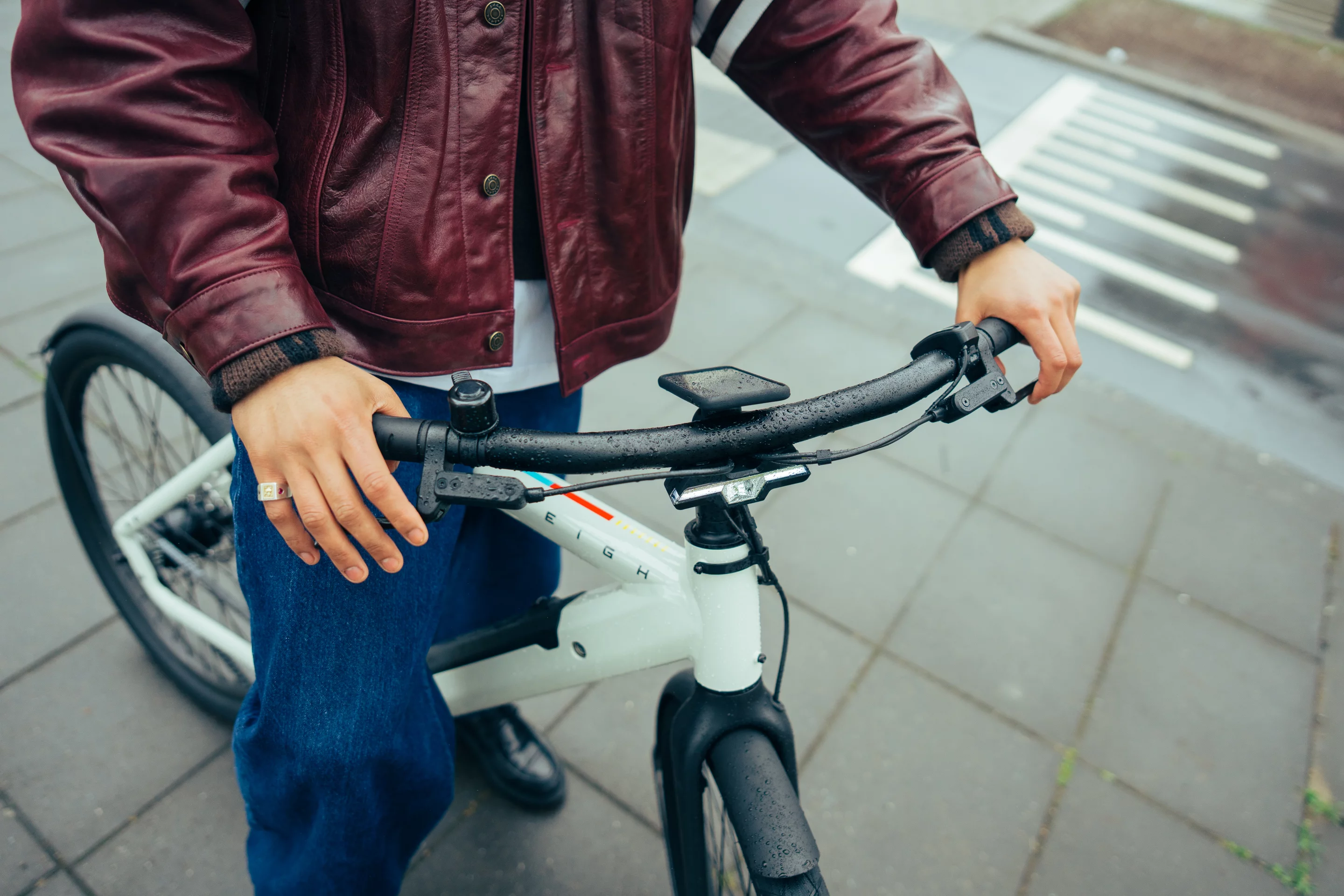 The Raleigh One features a step-over aluminum frame, a secure mount for a smartphone, dual-headlight and hydraulic disc braking