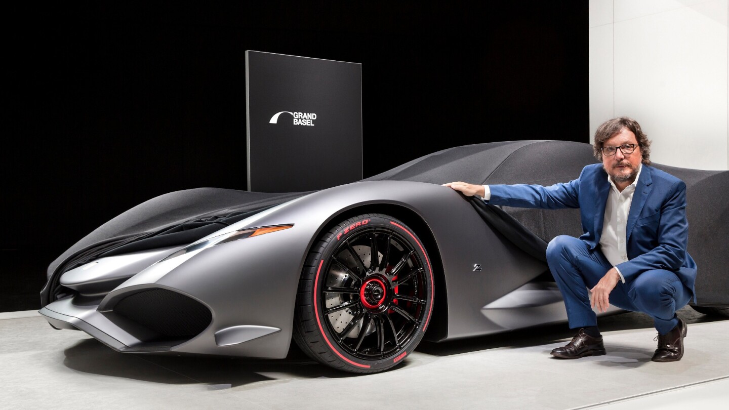 Andrea Zagato and his Zagato IsoRivolta Vision Grand Turismo Concept. The covers were only partially removed, with the full reveal planned for October when it will be available digitally as part of the Sony Playstation game series, Gran Turismo Sport. The concept is expected to be presented in full at Grand Basel 2018.