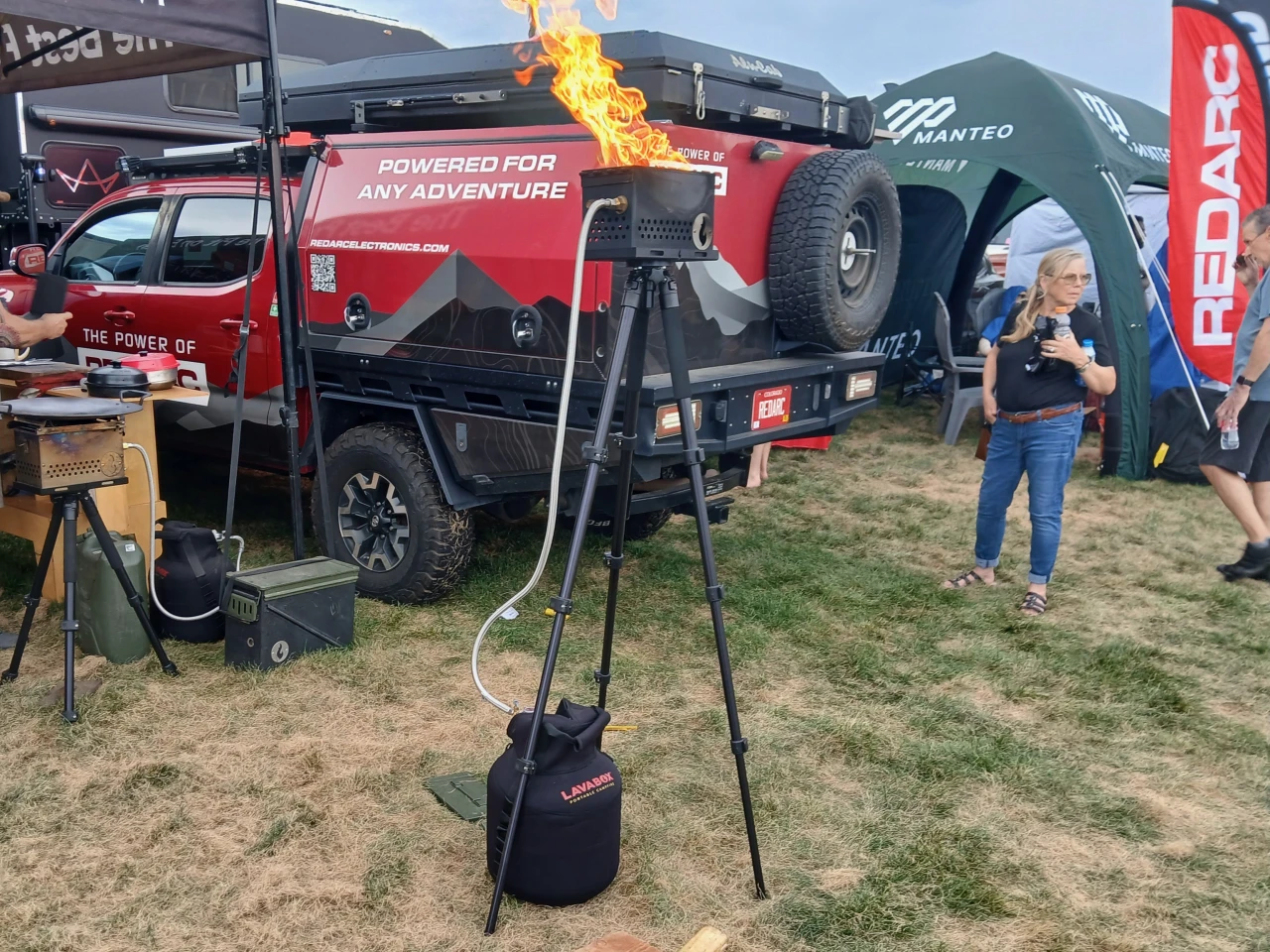 Lava Box's new Daddy Longlegs tripod stand looks handy for cooking on the propane fire pit, as set up in the backdrop to the left, but why does it lift that high? We were wary of getting anywhere close at Overland Expo and can't even imagine having that thing around a campsite where people are drinking, throwing around footballs and frisbees, and otherwise not expecting a giant flame on a tall, top-heavy stand at or above face level