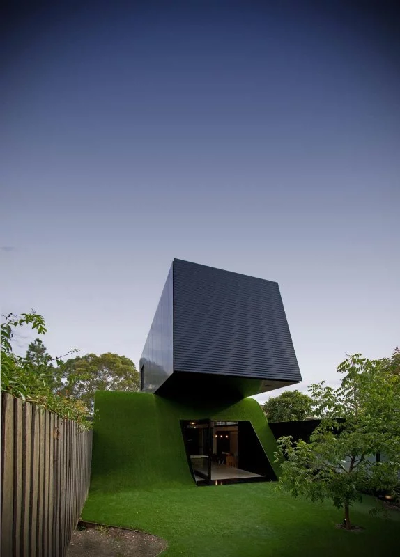 Hill House is an urban family home in Melbourne that appears as if it is riding a wave of grass