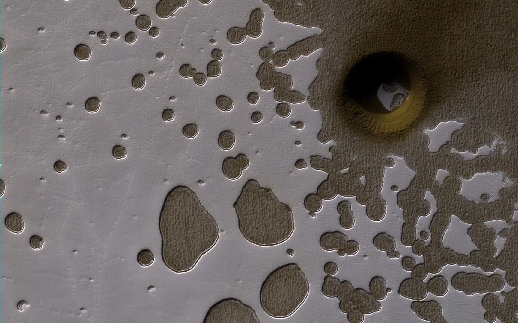 An impact crater or a polar pit on Mars