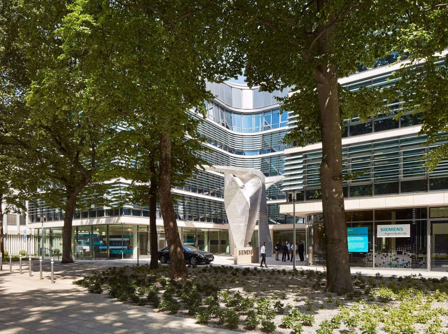 A sculptural artwork is located outside the building
