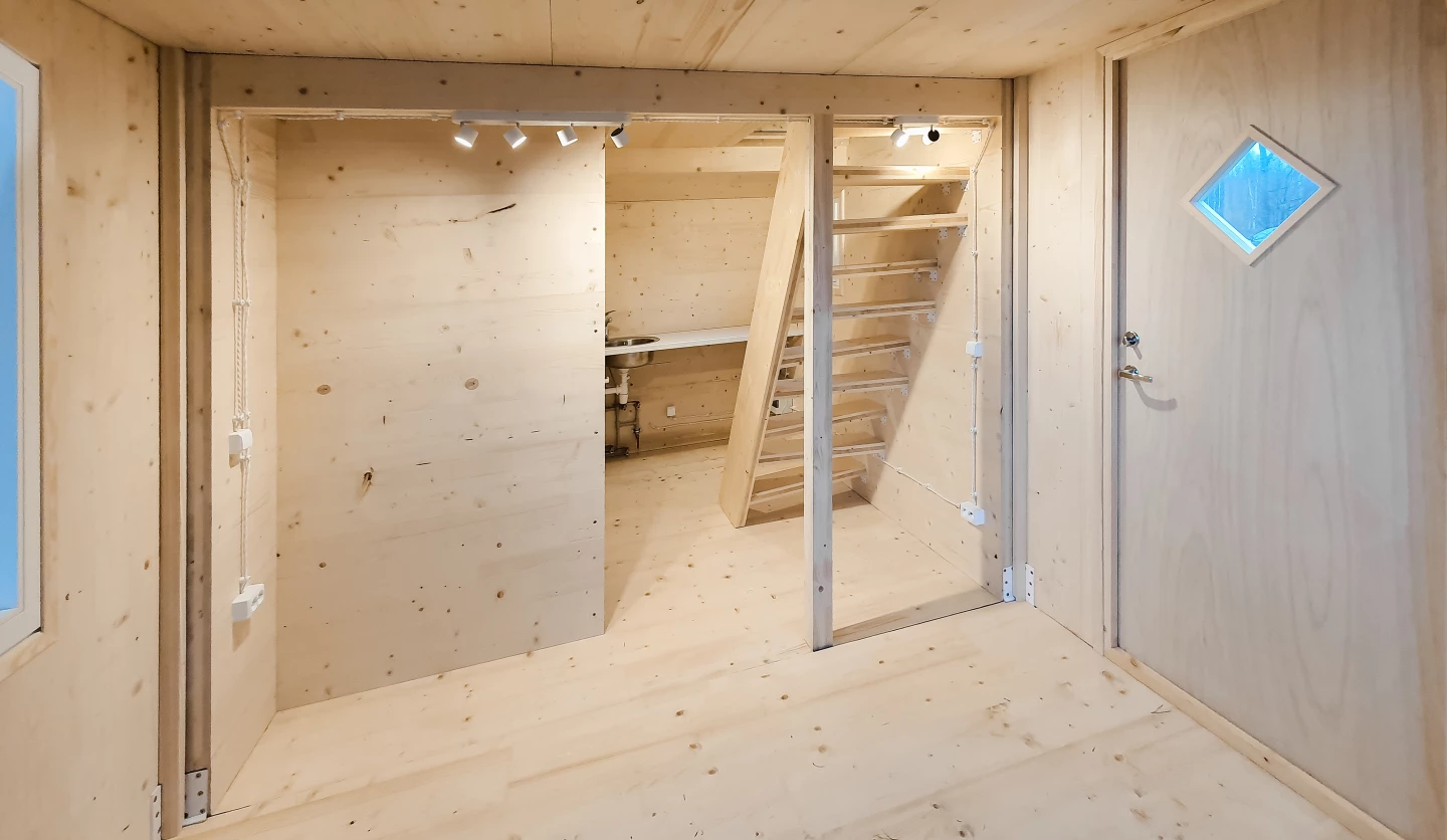 The Brette Haus' interior decor is simple and consists of unfinished wood