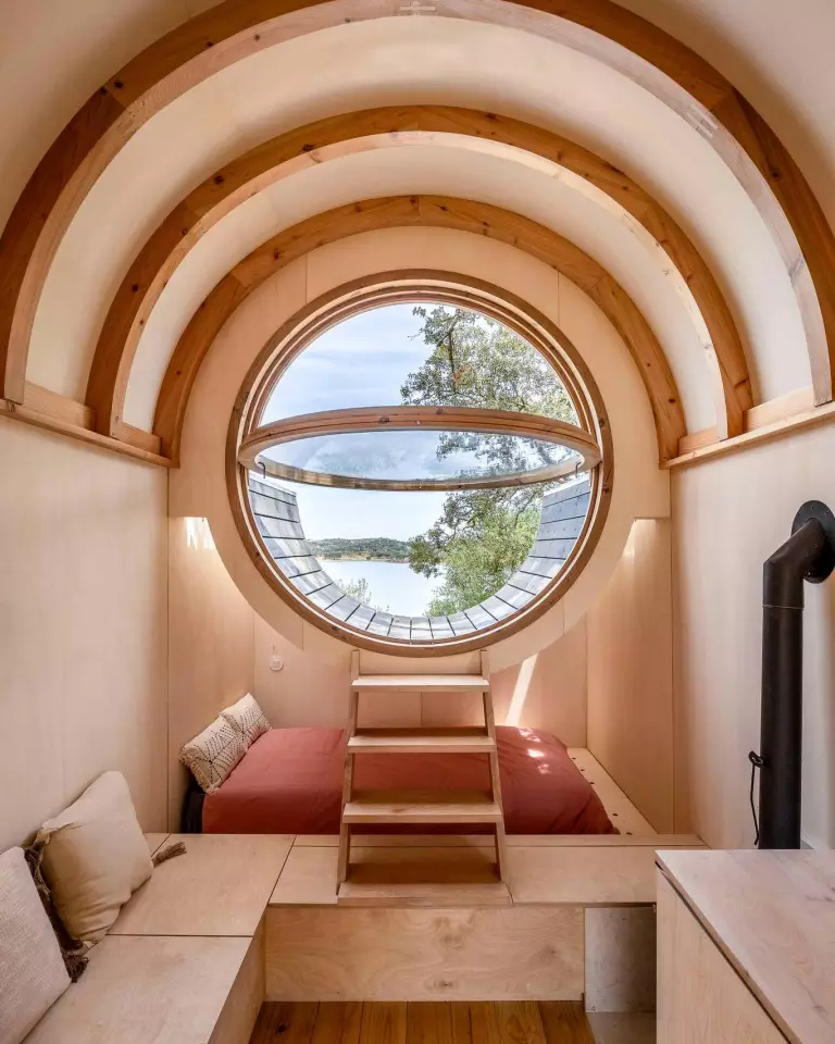 The Terra m1_Tiny House on Wheels includes removable steps to access the terrace area through porthole window