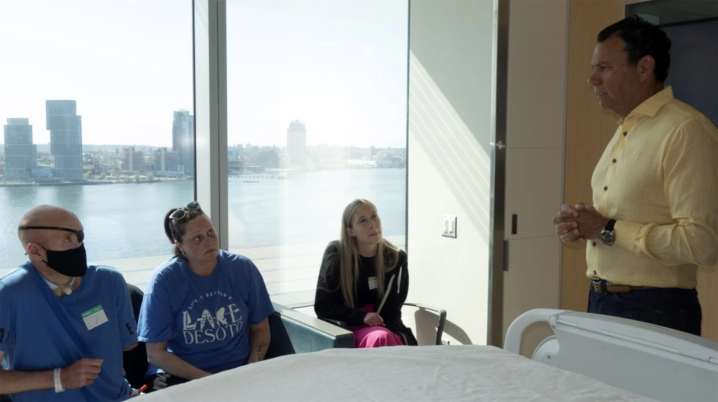 Aaron (far left) meets with Dr Eduardo Rodriguez (right) in May 2023 to discuss the transplant operation