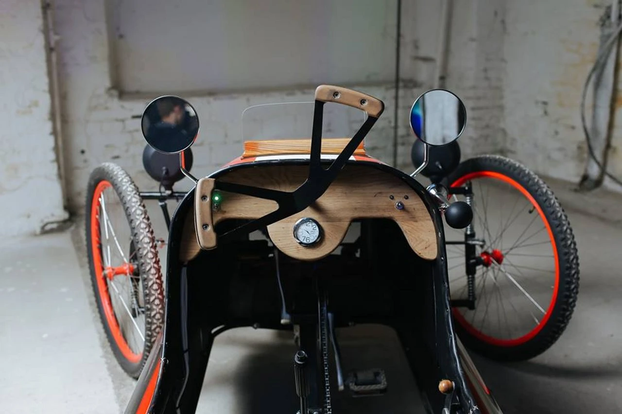 It features wood veneer and leather trim on the interior
