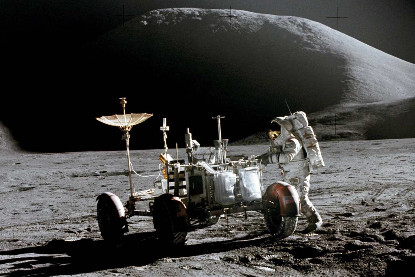 Astronaut James B. Irwin with a not-really-cool-looking lunar rover on the moon in 1971