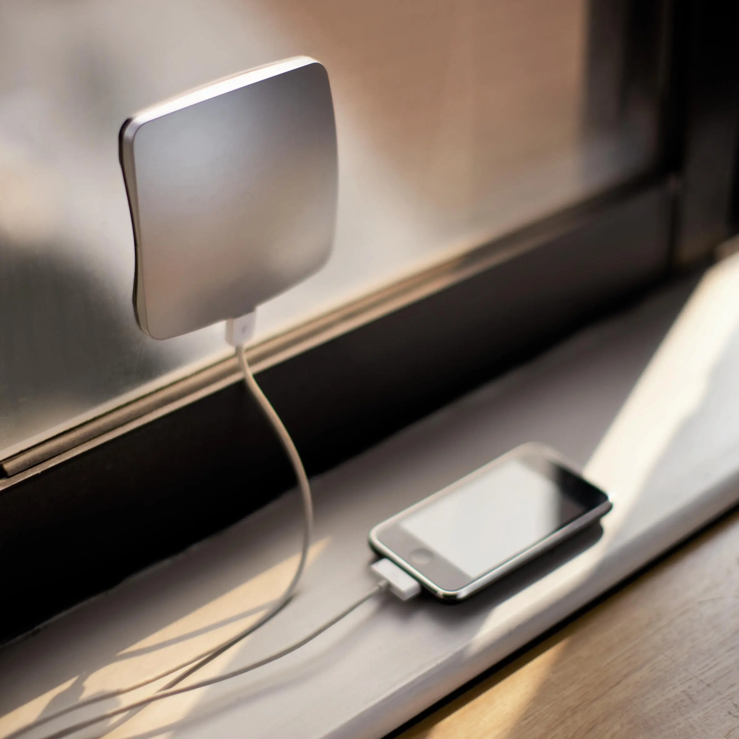 The XDModo Window solar charger sticks to the inside of a glass window pane so that the PV panel gets maximum exposure to the sun