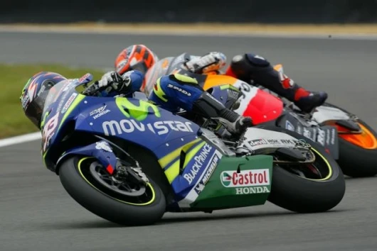 Melandri and Biaggi demonstrate extreme lean angles on their Honda RC211Vs as they fight over fourth spot