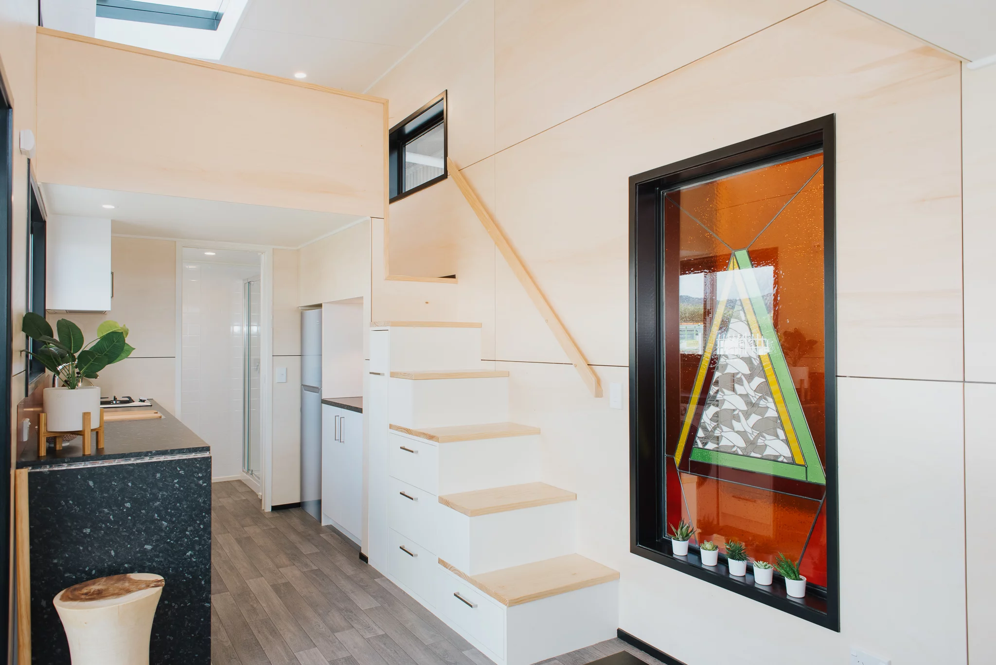 The Daisy Vera Tiny House's stained glass window is installed within a double glazed unit to protect it