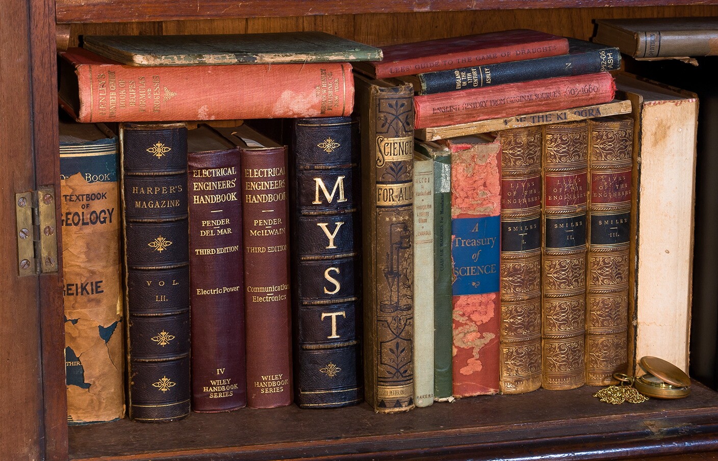 The replica Myst linking book as it looks sat on a bookshelf