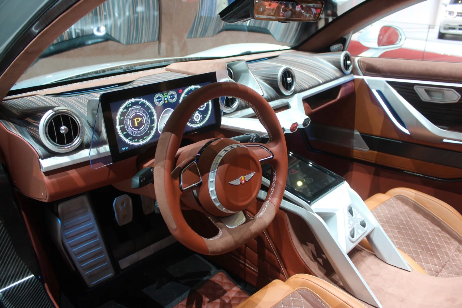The steering wheel is retro deluxe, and the dash is wood veneer, but the clocks are digital on glass, and somehow it all kind of works together