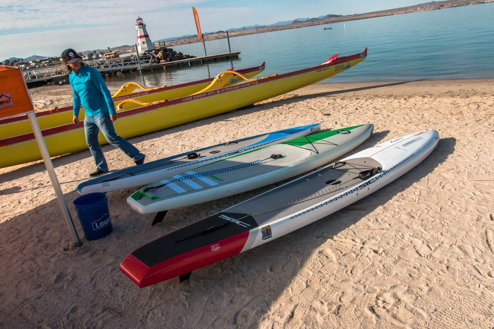 The 14-ft (4.2-m) carbon fiber SIC Rocket Ship RS pictured on the right is designed to be one of the fastest all-water race paddleboards on the market – and it'd want to be, at US$2,700. New bungee tie-downs for 2018 give it the ability to carry some gear while you're training or going long distances