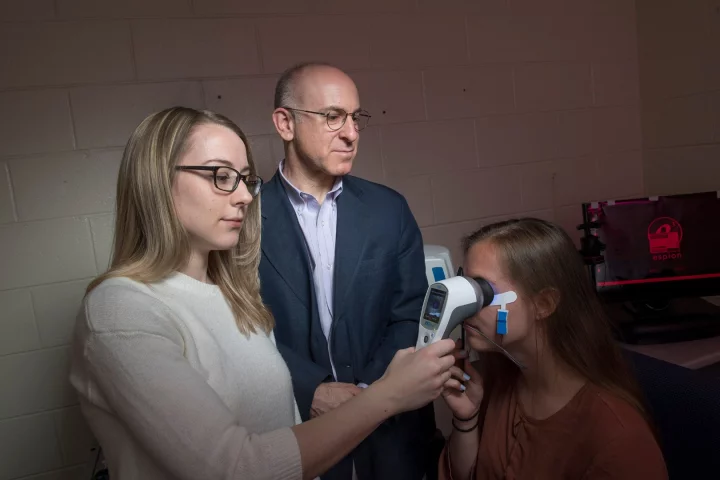 Docia Demmin (left) and Steven Silverstein, with the RETeval device