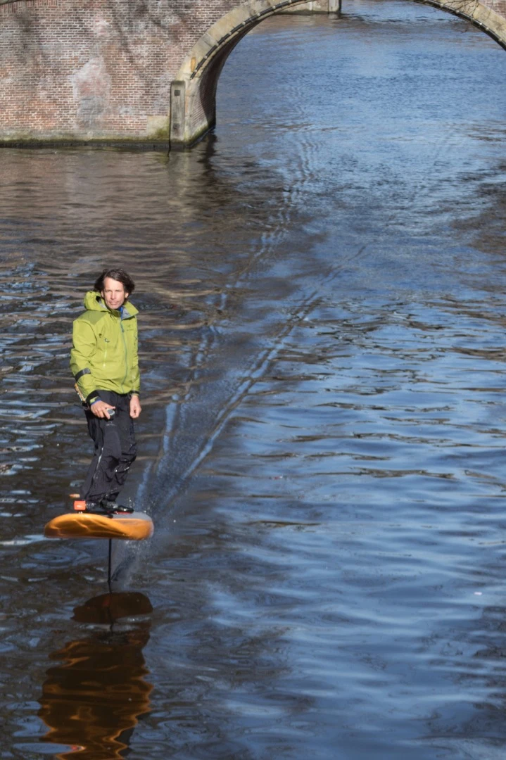 Inventor Don Montague rides his Jetfoiler board along Amsterdam's canals