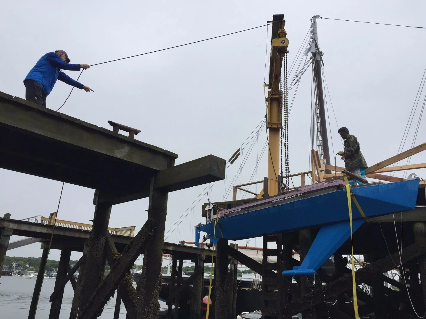 Solar Voyager is lowered into the water at Gloucester Harbor