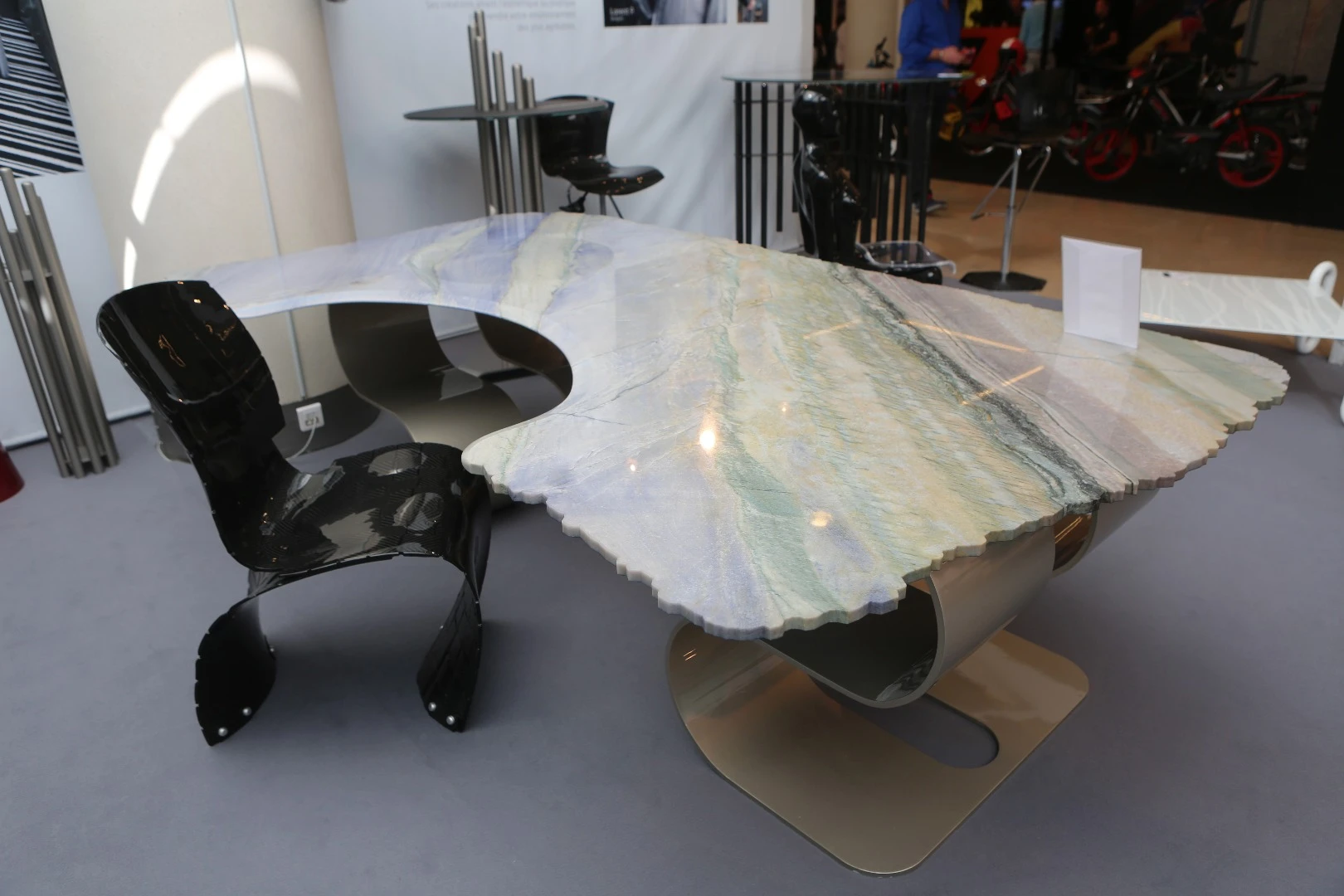 A marble Folie Concept desk and carbon fiber weave chair.