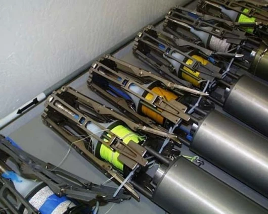 Close-up view of several autonomous mooring systems (without parachutes) attached to acoustic payloads that are developed for military and scientific uses.