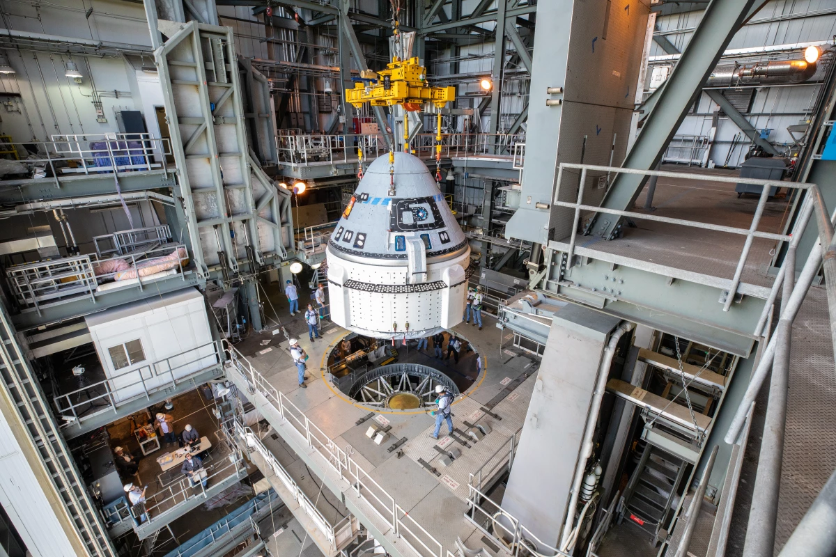 The Boeing CST-100 Starliner spacecraft is guided into position above a United Launch Alliance Atlas V rocket at the Vertical Integration Facility at Space Launch Complex 41 at Florida’s Cape Canaveral Air Force Station