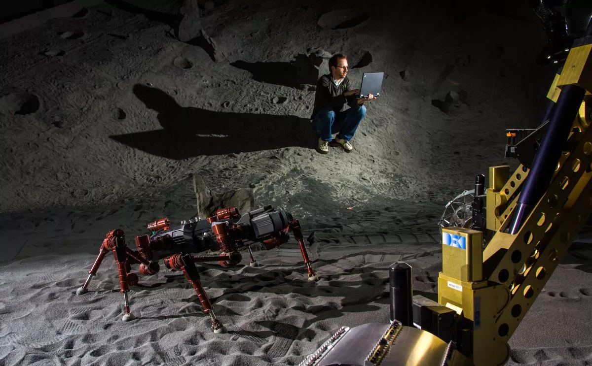 Robots and scientist in DFKI's artificial crater environment