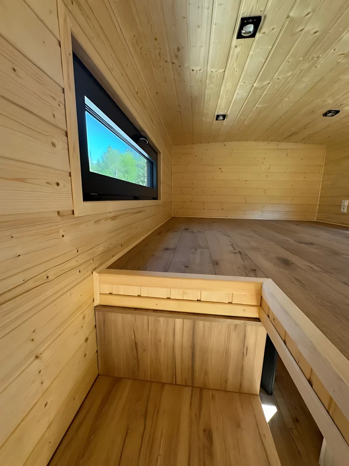 The Françoise's upstairs bedroom is accessed by storage-integrated staircase and includes a lowered standing platform to make it easier to get dressed