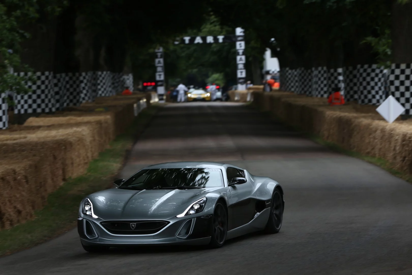 The Rimac Concept_One silently hustles up the hillclimb at Goodwood