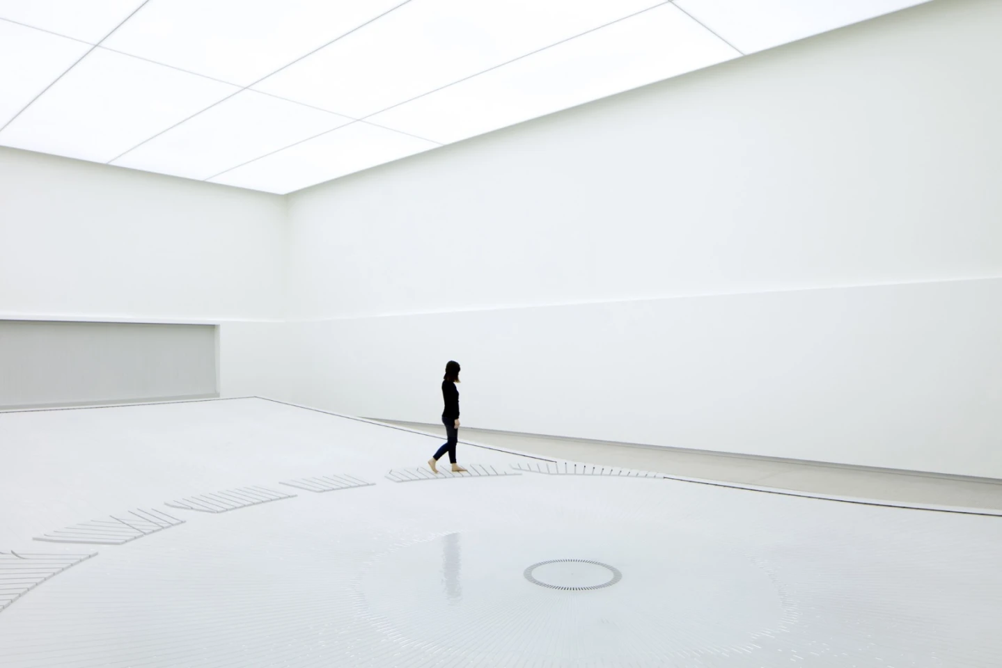 The water installation inside uses water droplets to create a visage resembling the sight of a giant city from space