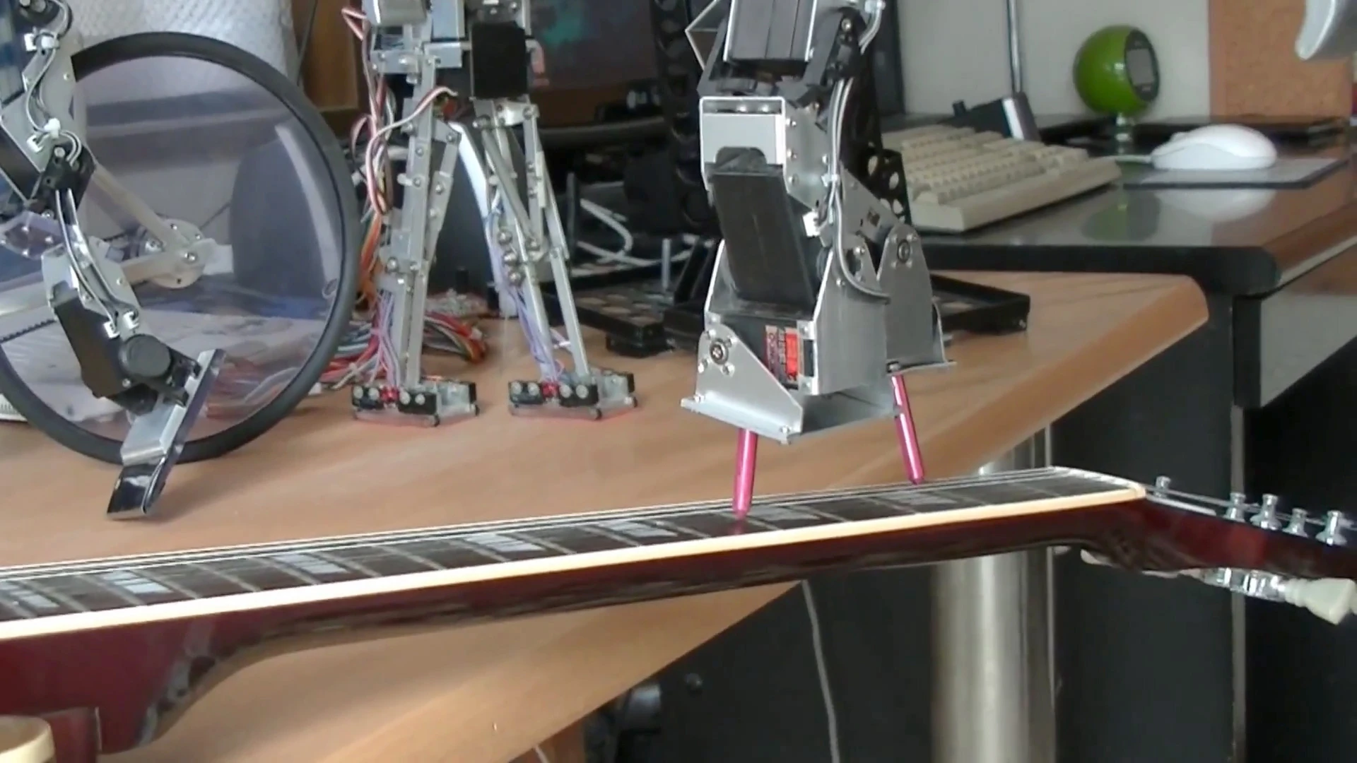 Close up: Dr. Guero's hobby robot kit balances on a guitar