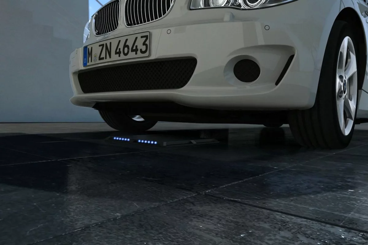 The BMW charging system uses a primary coil in the floor and a secondary coil in the car