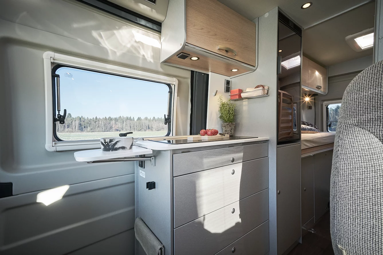 The Hymercar Free kitchen area houses a glass-top stove/sink, compressor fridge and extendable worktop