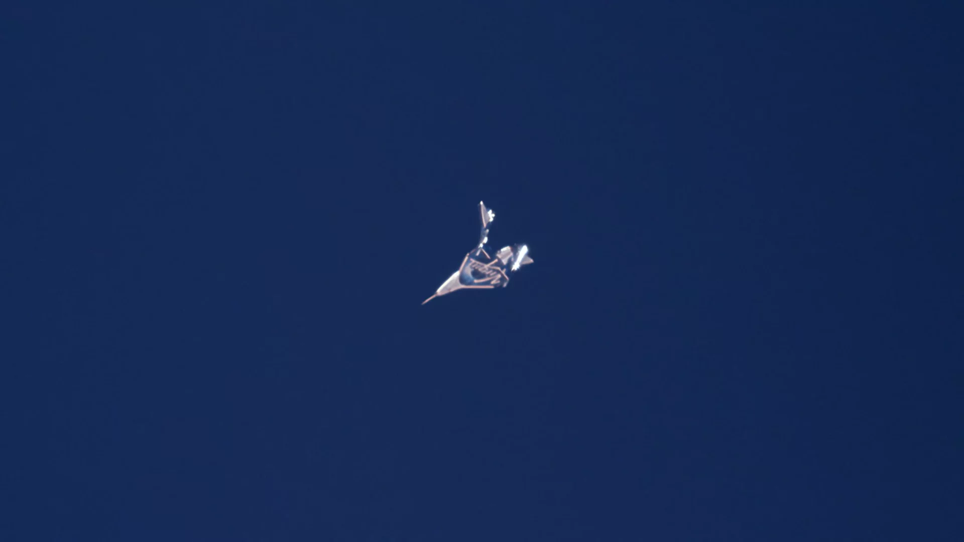 Virgin Galactic's spaceplane with its tail booms deployed