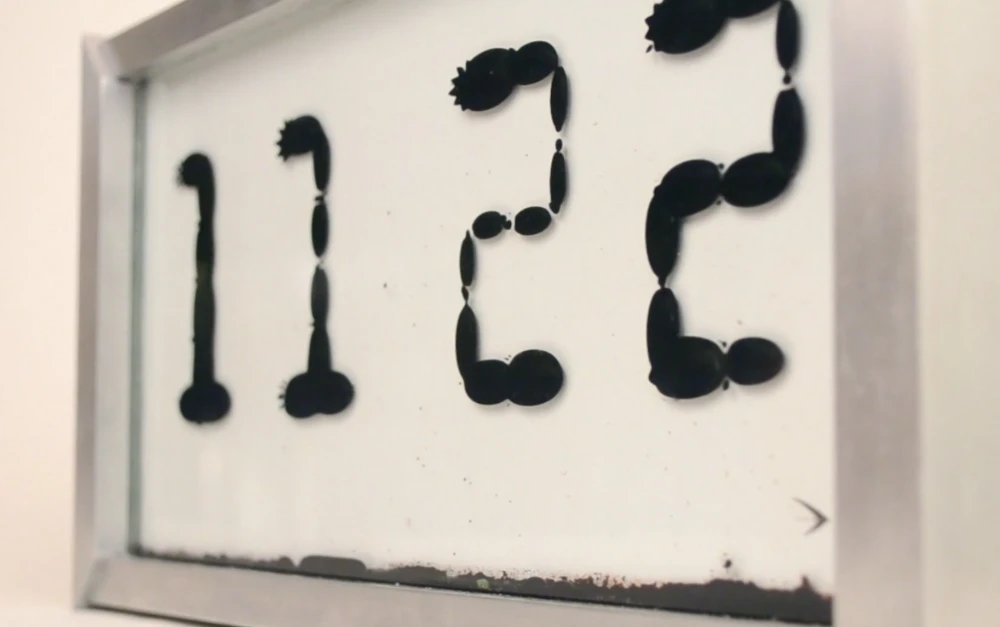 Ferrolic is a clock which tells the time by manipulating ferrofluid using electromagnets