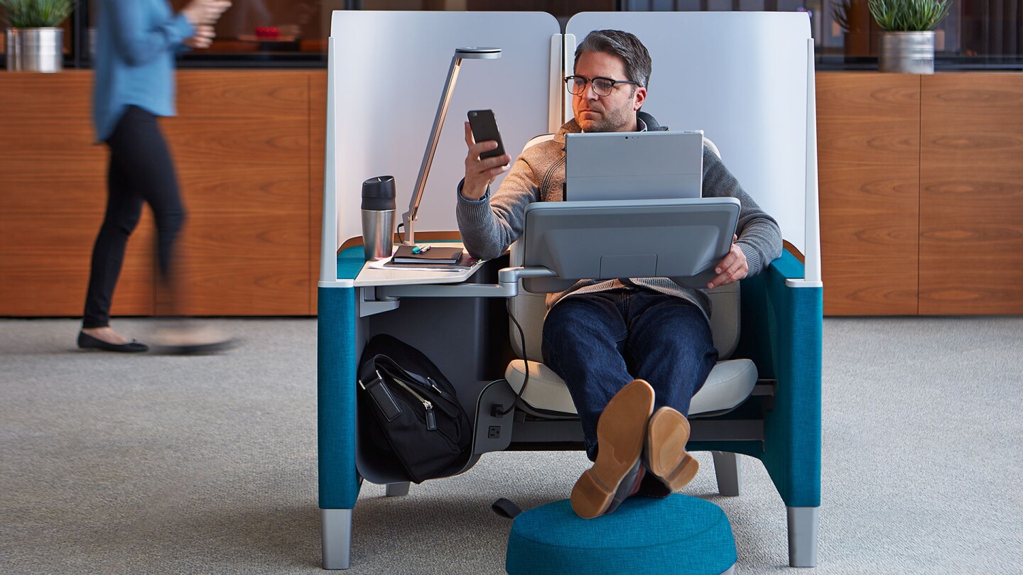 Each workspace is equipped with a main work surface, positioned on a swiveling arm that's adjustable up to 40 degrees of pitch