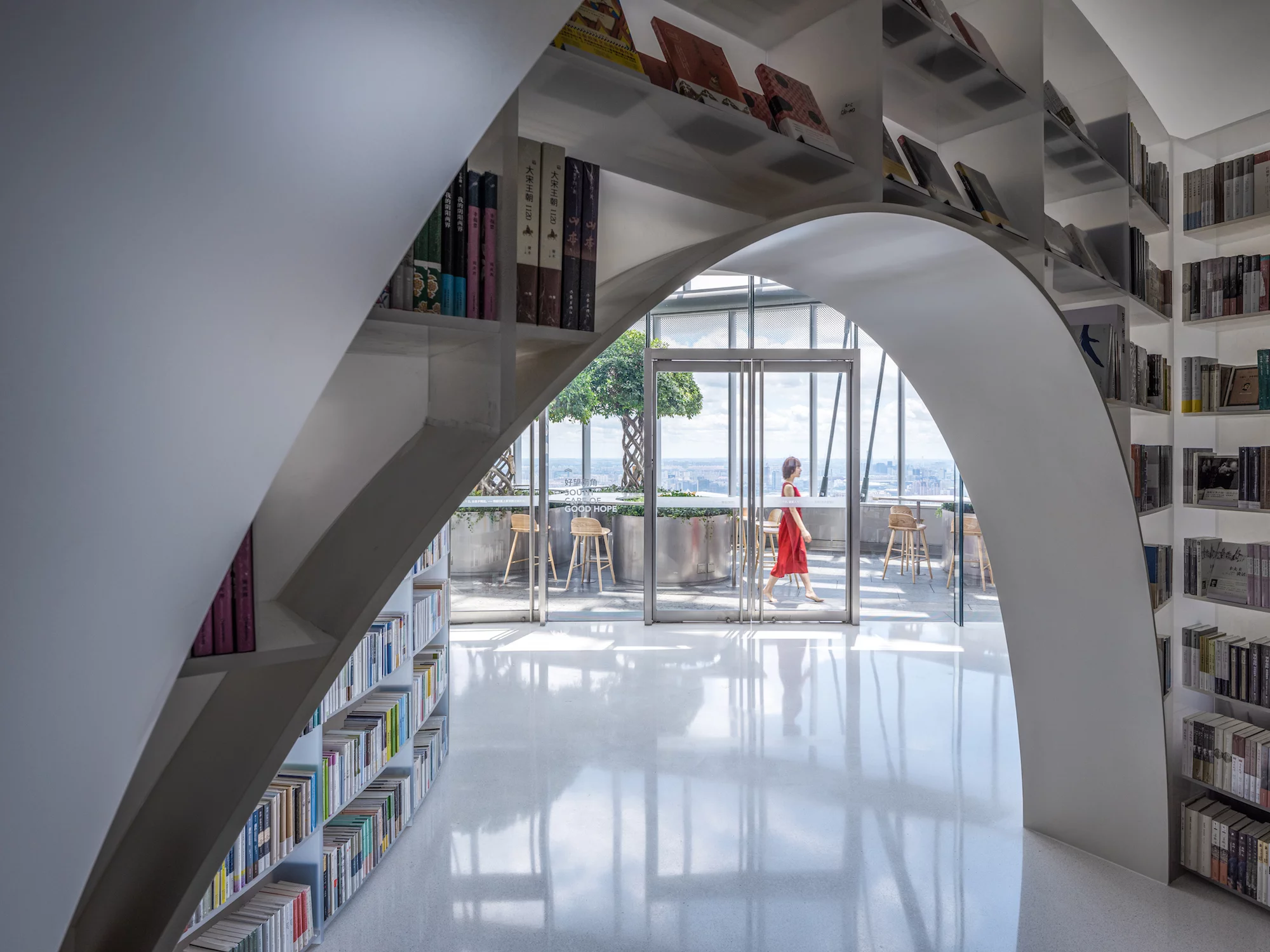 Books over the clouds' interior design is inspired by nature and the white bookshelves are envisioned as mountains